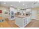 Bright kitchen with white cabinetry, stainless steel appliances, and a spacious center island at 6733 Jons, Zionsville, IN 46077