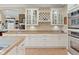 Eat-in kitchen features custom cabinetry, wine rack, stainless appliances and pantry at 6733 Jons, Zionsville, IN 46077