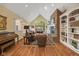 Spacious living room featuring a brick fireplace, hardwood floors, and comfortable seating at 6733 Jons, Zionsville, IN 46077