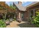 Charming brick patio with wrought iron seating, surrounded by lush trees, providing a peaceful outdoor space at 6733 Jons, Zionsville, IN 46077