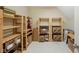 Ample storage room with wooden shelves and neutral tiles offering practical organization for belongings and supplies at 6733 Jons, Zionsville, IN 46077