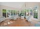 Bright sunroom with large windows, tiled floor, and comfortable seating area at 6733 Jons, Zionsville, IN 46077