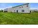 Spacious backyard featuring a large lawn, an outdoor fire pit, and vinyl siding on home at 6848 Harriet Dr, Indianapolis, IN 46237