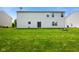 Backyard featuring a large lawn, outdoor fire pit, and sliding glass door entrance into the home at 6848 Harriet Dr, Indianapolis, IN 46237
