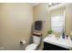 Neat half bath featuring a vanity with a black cabinet and a white sink and toilet at 6848 Harriet Dr, Indianapolis, IN 46237