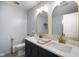 Bright bathroom with double sink vanity, marble countertop, and modern fixtures at 6848 Harriet Dr, Indianapolis, IN 46237