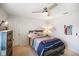 Cozy bedroom featuring a ceiling fan, complemented by a rustic bed frame and wooden dresser at 6848 Harriet Dr, Indianapolis, IN 46237