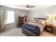 Well-lit bedroom with ceiling fan, dresser, and comfortable bed with rustic wooden frame at 6848 Harriet Dr, Indianapolis, IN 46237