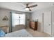 Bright bedroom with a ceiling fan, a view from the window, and vintage-style dresser at 6848 Harriet Dr, Indianapolis, IN 46237