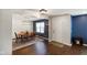 Open-concept dining area features hardwood floors, modern lighting, and stylish blue accent wall at 6848 Harriet Dr, Indianapolis, IN 46237