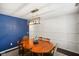 Bright dining room with natural lighting, paneled accent wall, and chandelier at 6848 Harriet Dr, Indianapolis, IN 46237