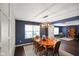 Cozy dining room with a decorative light fixture, wood floors, and modern paneled walls at 6848 Harriet Dr, Indianapolis, IN 46237