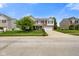 Charming two-story home with a well-manicured lawn, attached garage, and inviting front porch at 6848 Harriet Dr, Indianapolis, IN 46237