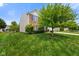 Well-maintained home with a lush green lawn, mature tree, and brick accents at 6848 Harriet Dr, Indianapolis, IN 46237