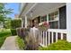 Inviting front porch with flower planters, decorative plants, and a cozy seating area at 6848 Harriet Dr, Indianapolis, IN 46237