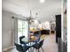 Eat-in kitchen features modern lighting, dark countertops, neutral floors, and ample natural light at 6848 Harriet Dr, Indianapolis, IN 46237