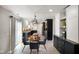 Bright eat-in kitchen featuring stylish light fixture, stainless appliances, and sliding glass door to exterior at 6848 Harriet Dr, Indianapolis, IN 46237