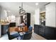 View of eat-in kitchen featuring black and white cabinets, stainless appliances, and decorative pendant lighting at 6848 Harriet Dr, Indianapolis, IN 46237