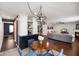 Open-concept living area with view into kitchen and dining area, featuring modern furnishings and neutral color palette at 6848 Harriet Dr, Indianapolis, IN 46237