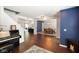 Spacious living room featuring a decorative fireplace, hardwood floors, and easy access to dining area at 6848 Harriet Dr, Indianapolis, IN 46237