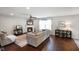 Bright living room featuring a fireplace, hardwood floors, and access to the dining area at 6848 Harriet Dr, Indianapolis, IN 46237