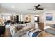 Open concept living room featuring a comfortable sectional sofa, ceiling fan, and access to the dining area at 6848 Harriet Dr, Indianapolis, IN 46237
