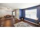 Bright living room featuring an electric fireplace and hardwood floors leading into the dining area at 6848 Harriet Dr, Indianapolis, IN 46237
