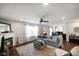 Bright living room with hardwood floors, a fireplace, and an open view of the kitchen at 6848 Harriet Dr, Indianapolis, IN 46237