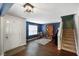 Spacious living room with hardwood floors, fireplace, and staircase at 6848 Harriet Dr, Indianapolis, IN 46237