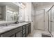 Bathroom featuring a double vanity with granite countertop and modern fixtures, next to the toilet and shower at 6902 Diamondleaf Way, Brownsburg, IN 46112