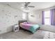 Bright bedroom with a cozy bed, stylish ceiling fan, and a large window at 6902 Diamondleaf Way, Brownsburg, IN 46112