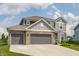 Beautiful two-story home showcasing a spacious driveway and attractive curb appeal on a sunny day at 6902 Diamondleaf Way, Brownsburg, IN 46112