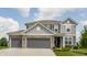 Charming two-story home featuring a two-car garage, manicured lawn, and classic architectural details at 6902 Diamondleaf Way, Brownsburg, IN 46112