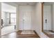 Bright foyer with wood floors, a large mirror, and an open view to the rest of the house at 6902 Diamondleaf Way, Brownsburg, IN 46112
