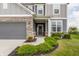 Inviting front porch featuring lush landscaping and a welcoming entrance to this lovely home at 6902 Diamondleaf Way, Brownsburg, IN 46112