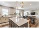 Open-concept kitchen with a large island, modern lighting, and seamless flow to the dining area at 6902 Diamondleaf Way, Brownsburg, IN 46112