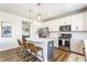 Bright kitchen with white cabinets, stainless steel appliances, and a center island with bar seating at 6902 Diamondleaf Way, Brownsburg, IN 46112