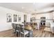 Open-concept kitchen and dining area featuring modern appliances, ample counter space, and stylish decor at 6902 Diamondleaf Way, Brownsburg, IN 46112
