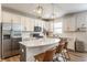 Stylish kitchen with stainless steel appliances, herringbone backsplash, and an island with seating at 6902 Diamondleaf Way, Brownsburg, IN 46112