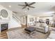 Open-concept living room with hardwood floors, a fireplace, and seamlessly connected kitchen and dining areas at 6902 Diamondleaf Way, Brownsburg, IN 46112