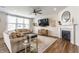 Comfortable living room featuring a fireplace, TV, stylish decor, and ample seating for Gathering and guests at 6902 Diamondleaf Way, Brownsburg, IN 46112
