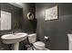 Chic powder room featuring modern fixtures, dark walls, and decorative accents at 6902 Diamondleaf Way, Brownsburg, IN 46112