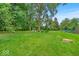 Spacious backyard featuring a gazebo surrounded by mature trees and a large lawn at 7502 Colony Cir, Indianapolis, IN 46260