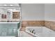 Bright bathroom features a soaking tub, a shower, and double sink vanity at 7502 Colony Cir, Indianapolis, IN 46260