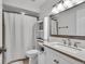 Bright bathroom featuring white shower curtain, vanity with mirror and recessed lighting at 7502 Colony Cir, Indianapolis, IN 46260