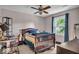 Cozy bedroom with a ceiling fan, natural light, and neutral color palette at 7502 Colony Cir, Indianapolis, IN 46260