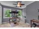 Functional bedroom used as a home office, featuring a window view and modern ceiling fan at 7502 Colony Cir, Indianapolis, IN 46260