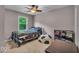 Cozy bedroom with a ceiling fan, natural light from a window and carpet flooring at 7502 Colony Cir, Indianapolis, IN 46260