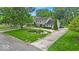 Two-story home with beautiful landscaping, well-manicured lawn, and circular driveway at 7502 Colony Cir, Indianapolis, IN 46260