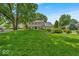Inviting two-story home boasts lush front lawn and meticulously maintained landscaping, offering great curb appeal at 7502 Colony Cir, Indianapolis, IN 46260